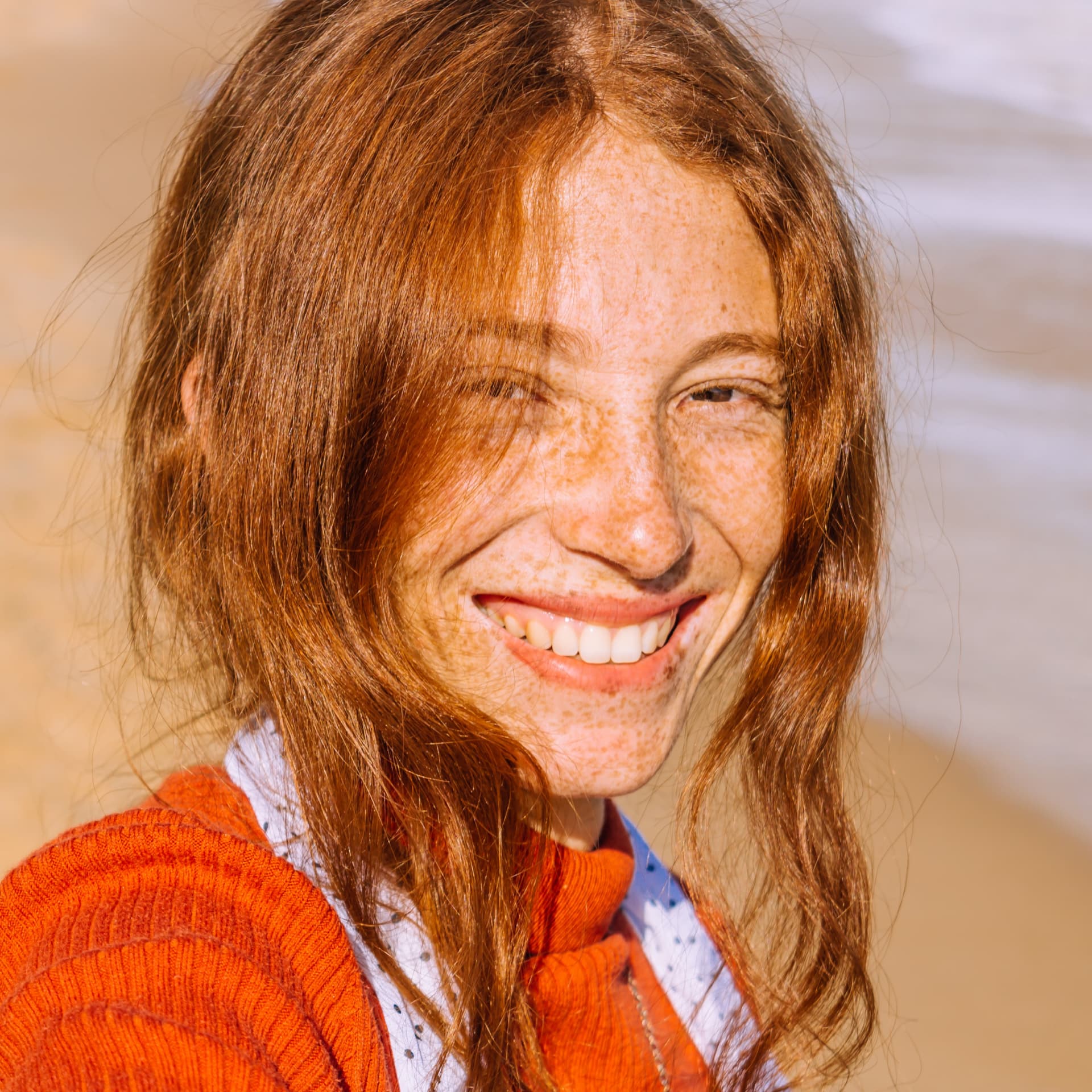 Sarah Thompson, a red-haired client, holding her small dog