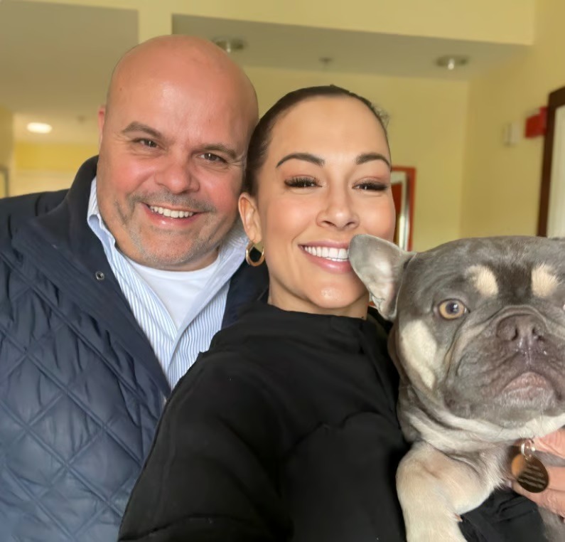 The Pampered Puppies owners holding their french bulldog